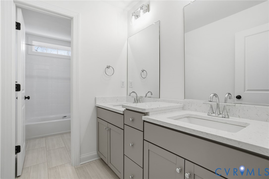 1404 Mill Quarter Road Powhatan, VA 23139 - Photo 21 of 29 a bathroom with a granite countertop sink and a mirror