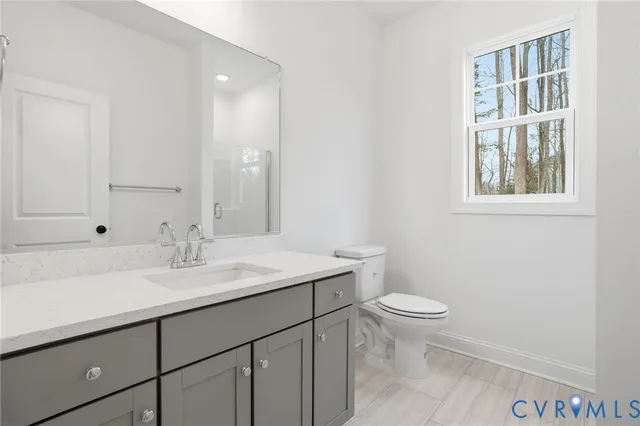 a bathroom with a sink a toilet and a window