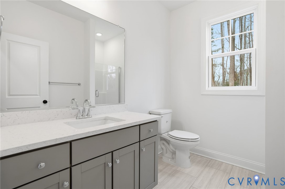 1404 Mill Quarter Road Powhatan, VA 23139 - Photo 22 of 29 a bathroom with a sink a toilet and a window