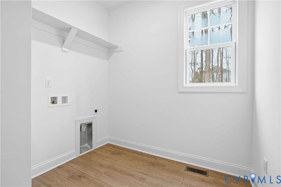 1404 Mill Quarter Road Powhatan, VA 23139 - Photo 25 of 29 a view of an empty room with wooden floor and a window