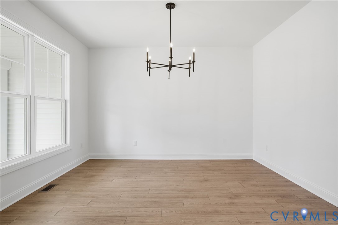 1404 Mill Quarter Road Powhatan, VA 23139 - Photo 8 of 29 a view of a room with wooden floor and white walls