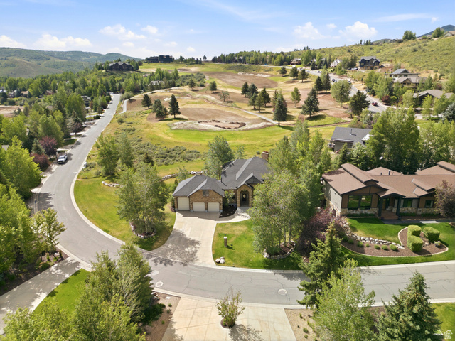 3535 Homestead Road Park City, UT 84098 - Photo 75 of 81 Expansive property on a curved street, featuring a paved driveway, attached two-car garage, and mature landscaping