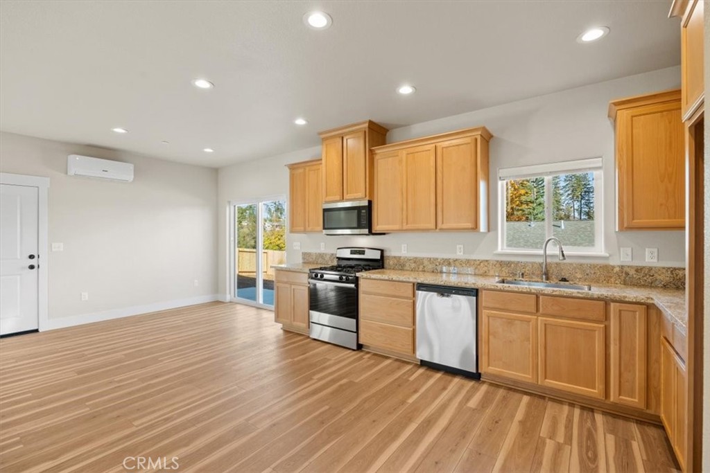 1309 Nunneley Road Paradise, CA 95969 - Photo 11 of 22 a kitchen with stainless steel appliances granite countertop wooden cabinets a sink and a stove