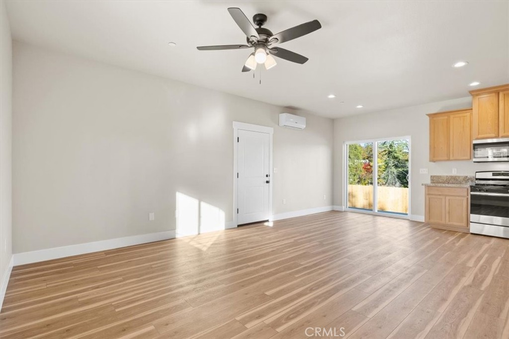 1309 Nunneley Road Paradise, CA 95969 - Photo 13 of 22 a view of an empty room with window and wooden floor