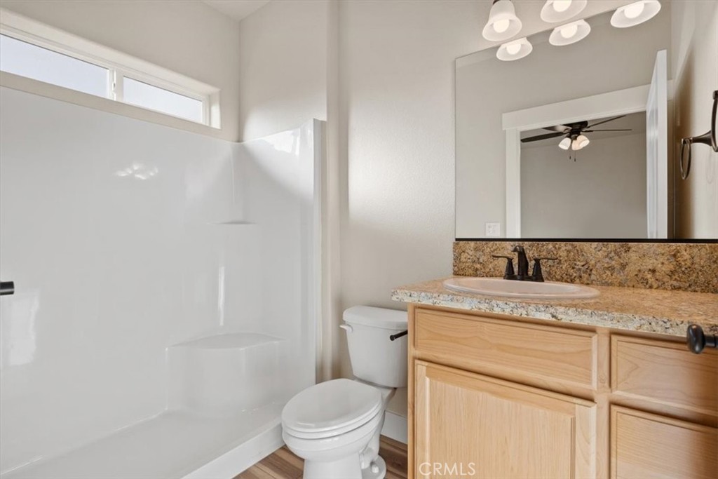 1309 Nunneley Road Paradise, CA 95969 - Photo 16 of 22 a bathroom with a granite countertop sink toilet and shower