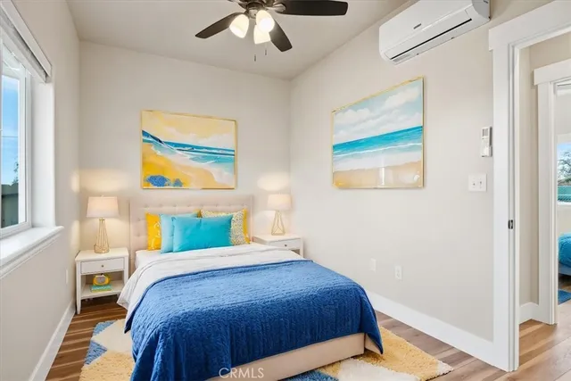 a bedroom with a bed and a painting on the wall