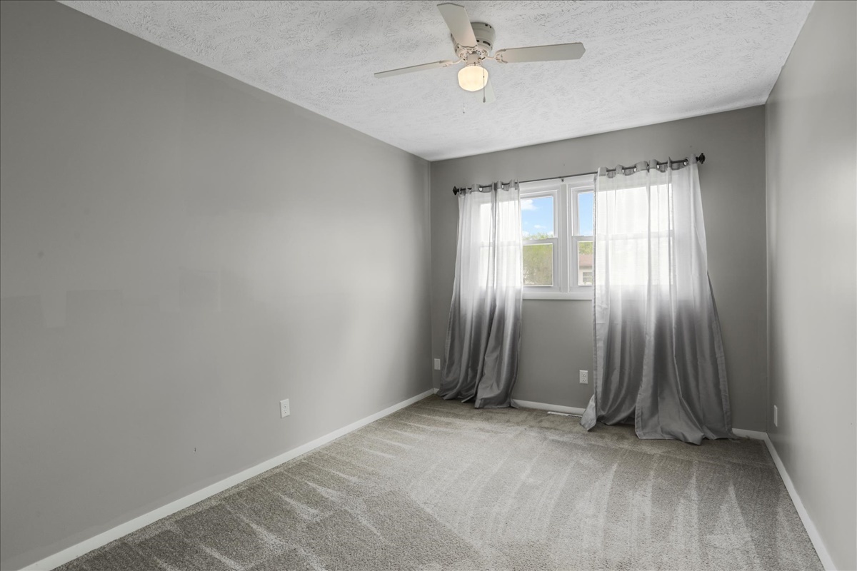 1717 King Drive, Unit B Normal, IL 61761 - Photo 11 of 18 an empty room with windows and closet area