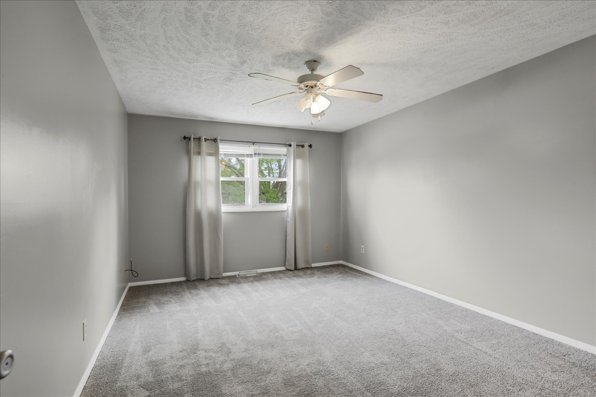 1717 King Drive, Unit B Normal, IL 61761 - Photo 13 of 18 an empty room with a chandelier fan and windows