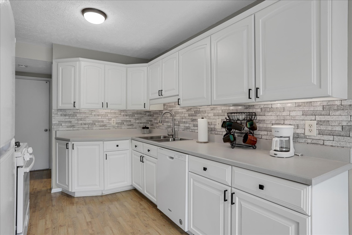 1717 King Drive, Unit B Normal, IL 61761 - Photo 5 of 18 a kitchen with granite countertop white cabinets and white appliances