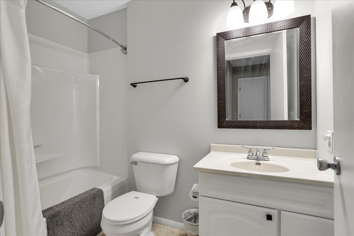 1717 King Drive, Unit B Normal, IL 61761 - Photo 10 of 18 a bathroom with a sink toilet vanity and shower