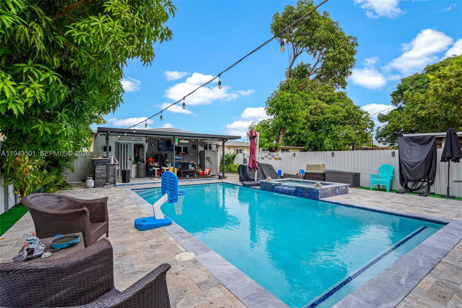 864 East 29th Street Hialeah, FL 33013 - Photo 11 of 16 a view of a backyard with table and chairs potted plants and a fire pit
