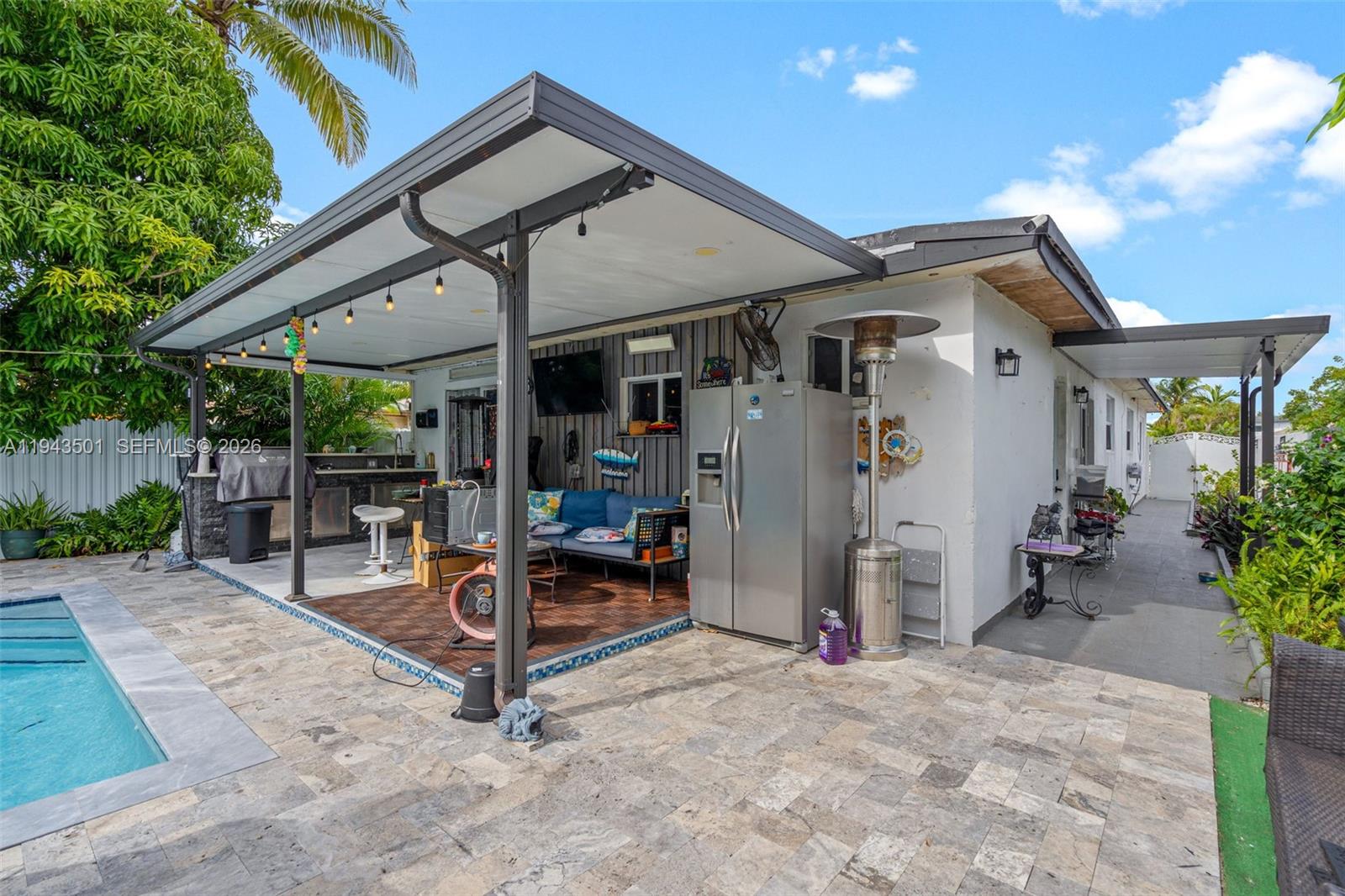 864 East 29th Street Hialeah, FL 33013 - Photo 8 of 16 a view of a patio with a table and chairs under an umbrella