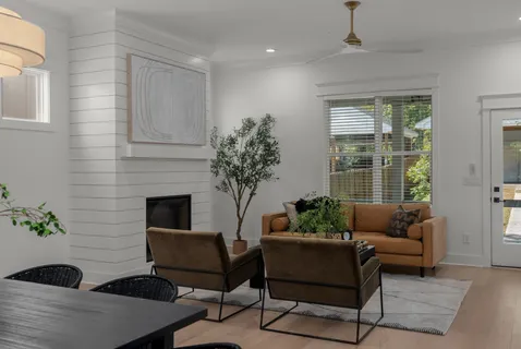 a living room with furniture potted plant and a window