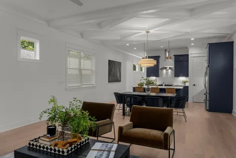 a living room with furniture and a chandelier