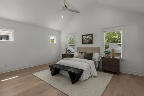 a bedroom with a bed lamp and a window