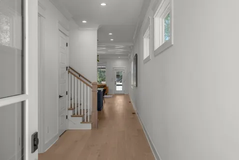 a view of a hallway with wooden floor