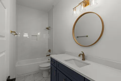 a bathroom with a sink a toilet and a mirror