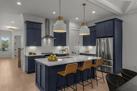 a kitchen with a sink refrigerator and cabinets