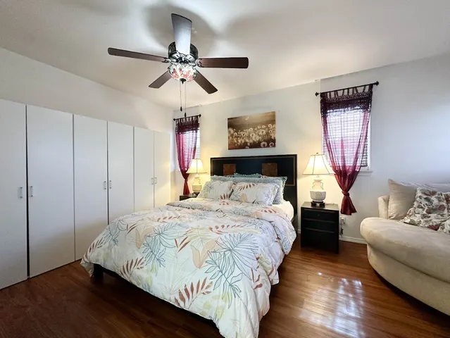 a bedroom with bed and a chandelier
