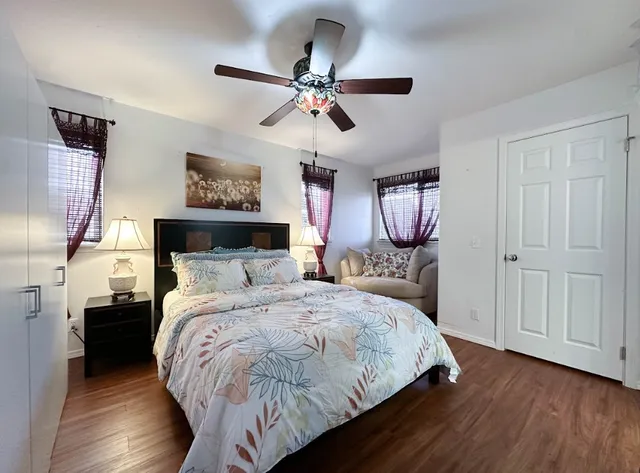 a bedroom with bed and wooden floor