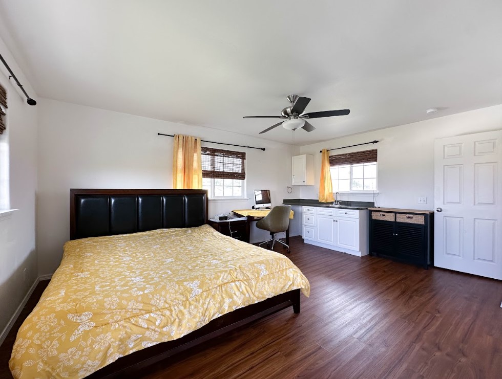 67-1310 Puaena Street Kamuela, HI 96743 - Photo 14 of 26 a large bedroom with a bed and window