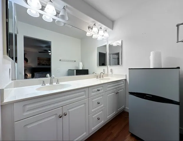 a bathroom with a double vanity sink mirror and