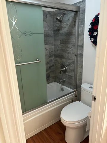 a bathroom with a toilet and a shower