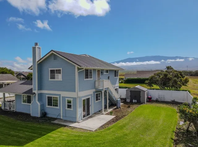 a aerial view of a house with a yard table and chairs