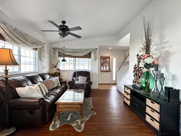 a living room with furniture fireplace and potted plants
