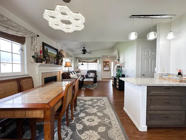 a view of a dining room with furniture a chandelier and wooden floor
