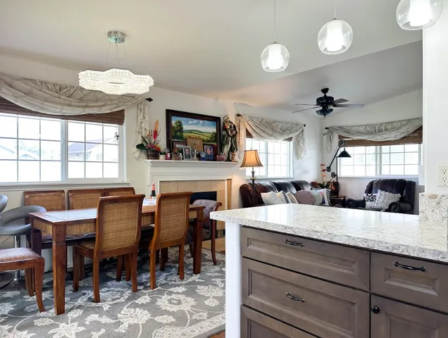 a large kitchen with a table chairs and a fireplace