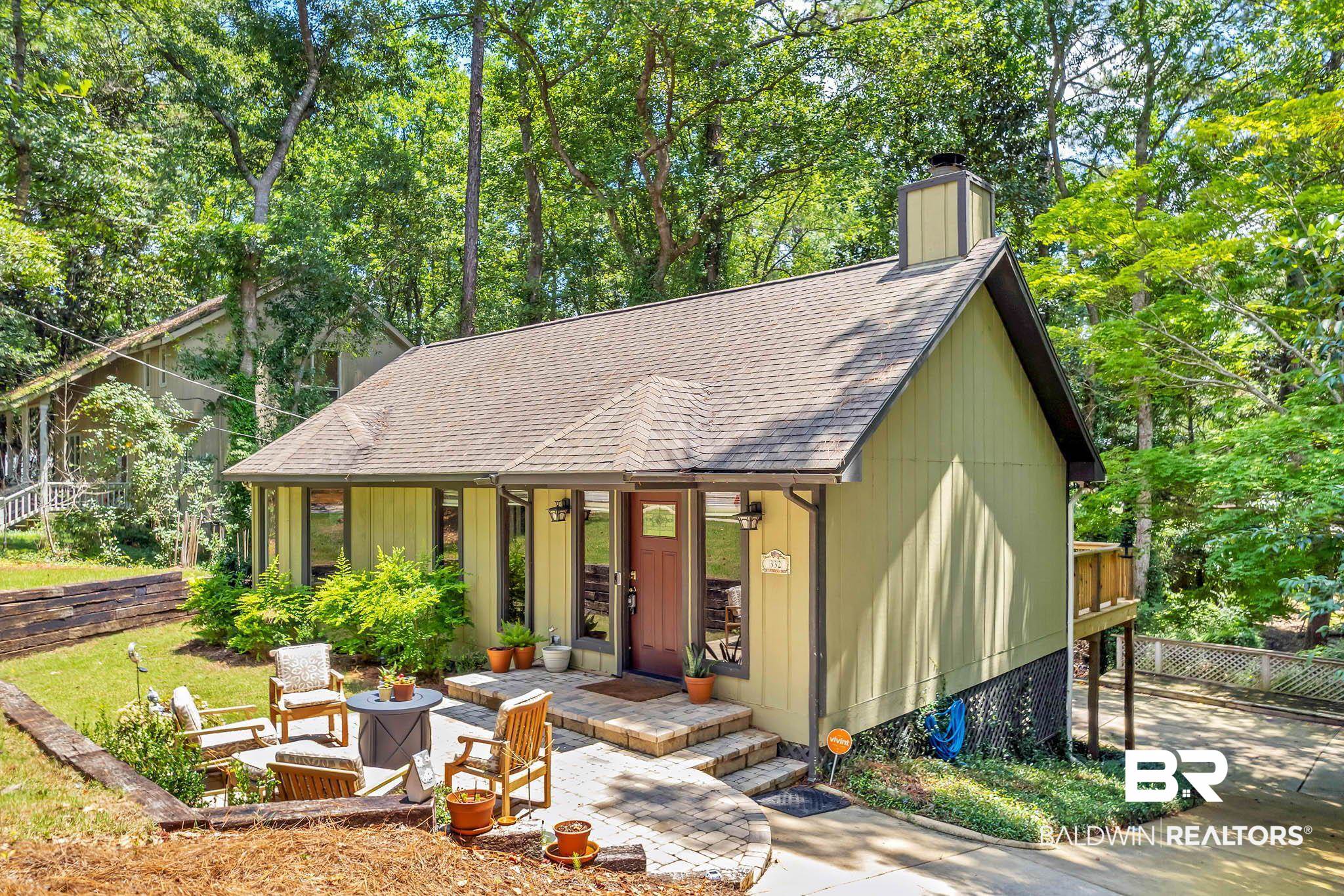 332 Ridgewood Drive Daphne, AL 36526 - Photo 3 of 48 Chalet / cabin featuring roof with shingles, a chimney, and view of scattered trees