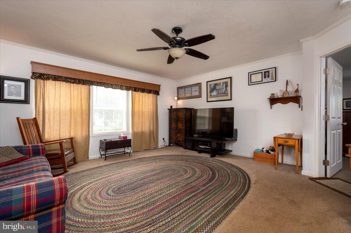 302 Berts Drive Lothian, MD 20711 - Photo 11 of 38 a view of livingroom with furniture and a flat screen tv
