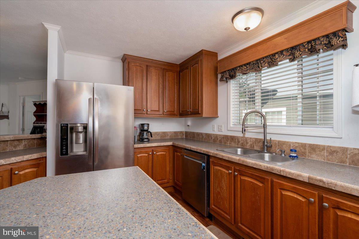 302 Berts Drive Lothian, MD 20711 - Photo 19 of 38 a kitchen with stainless steel appliances granite countertop a sink refrigerator and cabinets