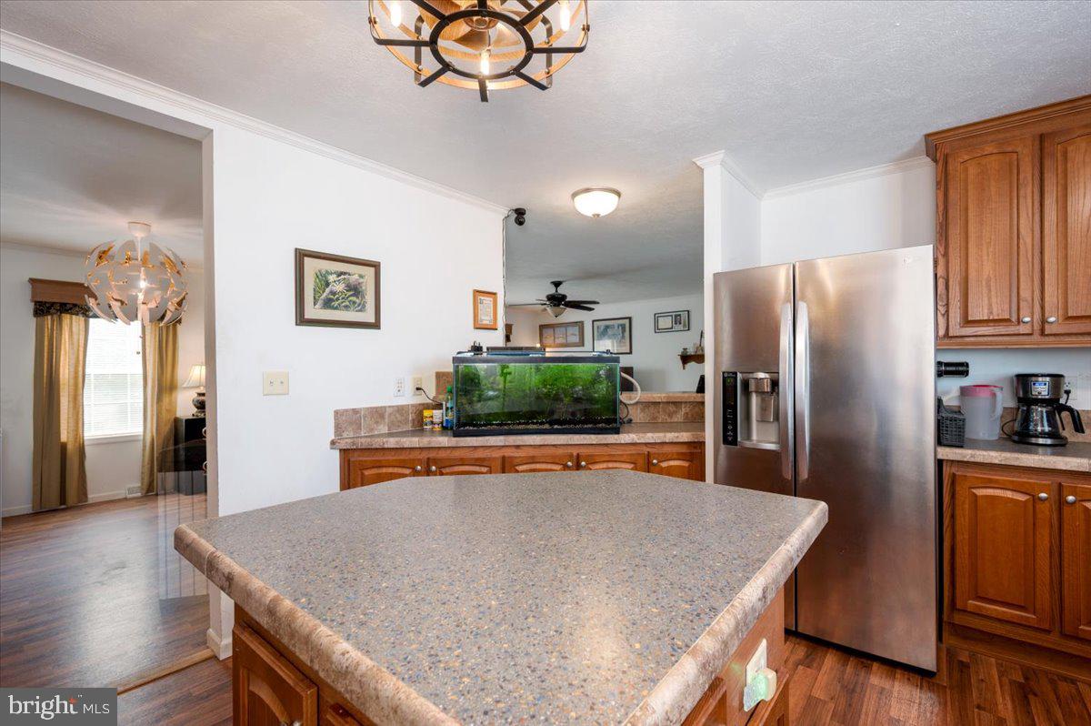 302 Berts Drive Lothian, MD 20711 - Photo 20 of 38 a kitchen with stainless steel appliances granite countertop a refrigerator a stove top oven a sink dishwasher and white cabinets with wooden floor