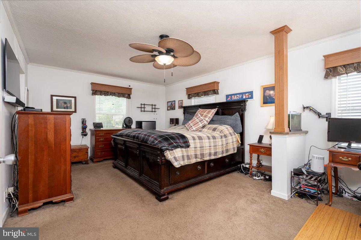 302 Berts Drive Lothian, MD 20711 - Photo 21 of 38 a bedroom with a bed and a chandelier