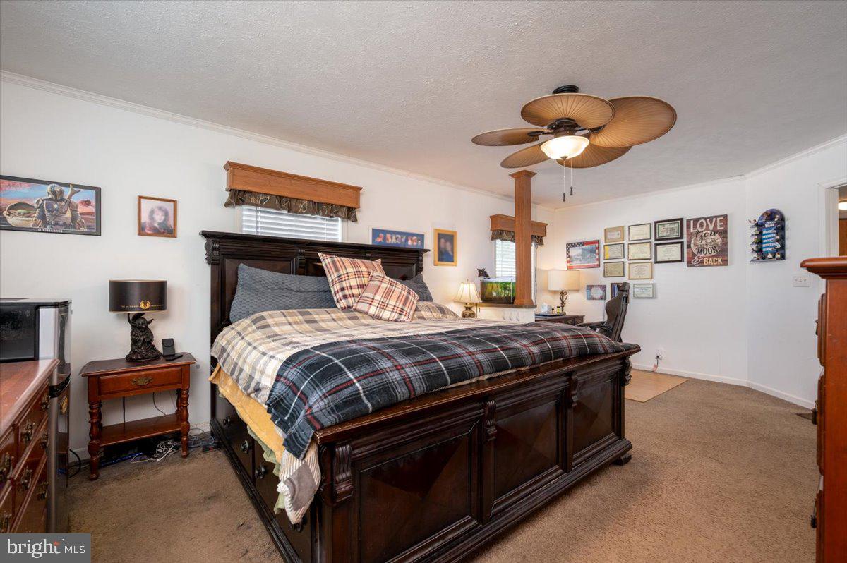 302 Berts Drive Lothian, MD 20711 - Photo 24 of 38 a bedroom with a bed and a chandelier