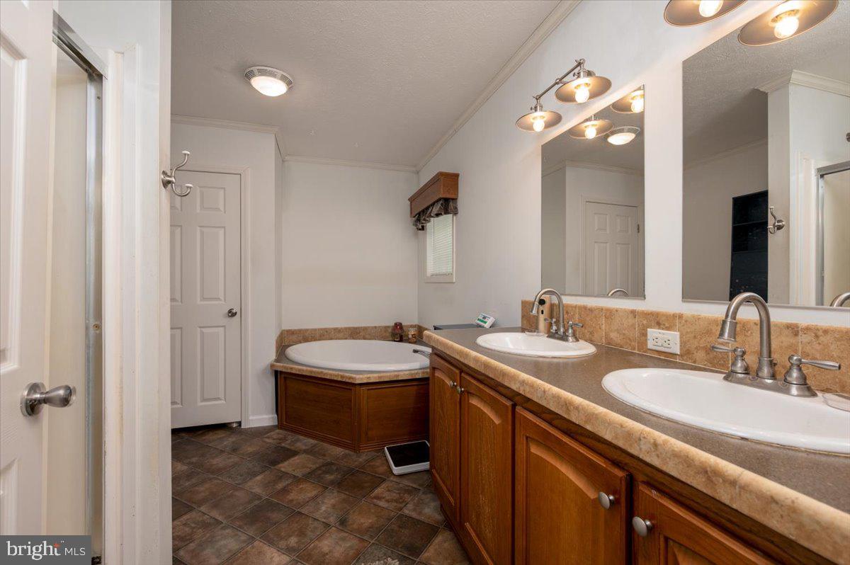 302 Berts Drive Lothian, MD 20711 - Photo 25 of 38 a bathroom with a granite countertop sink a toilet and a mirror
