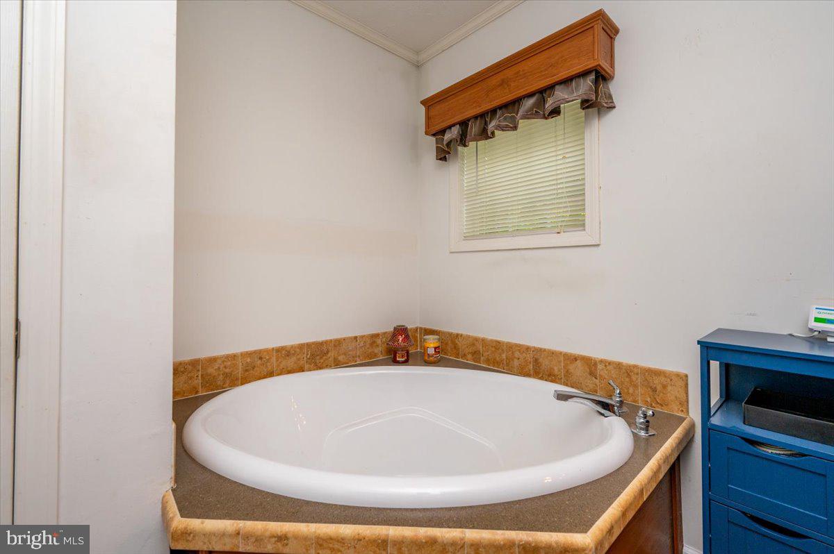 302 Berts Drive Lothian, MD 20711 - Photo 26 of 38 a bathroom with a bathtub and a window