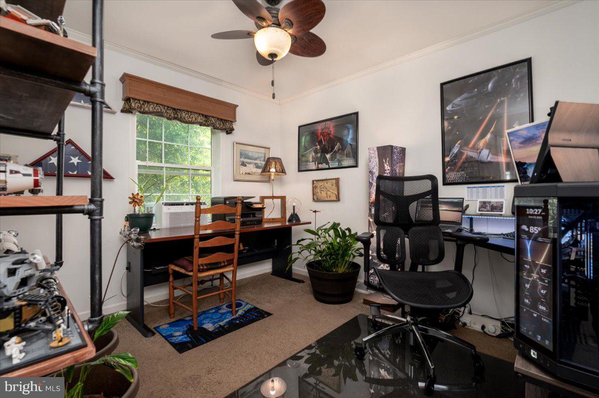 302 Berts Drive Lothian, MD 20711 - Photo 31 of 38 a view of a workspace with furniture and a potted plant