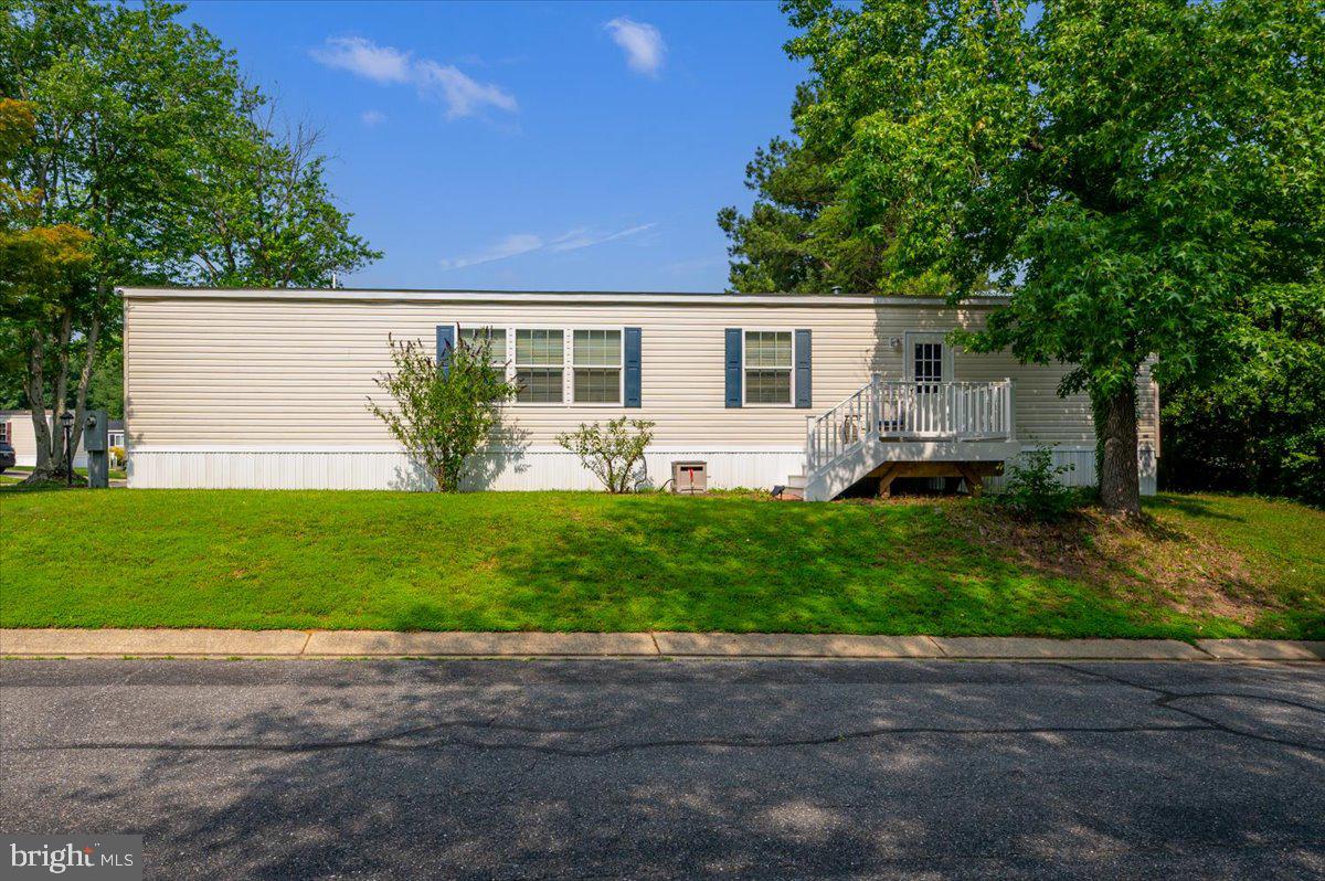 302 Berts Drive Lothian, MD 20711 - Photo 4 of 38 a front view of house with yard and green space