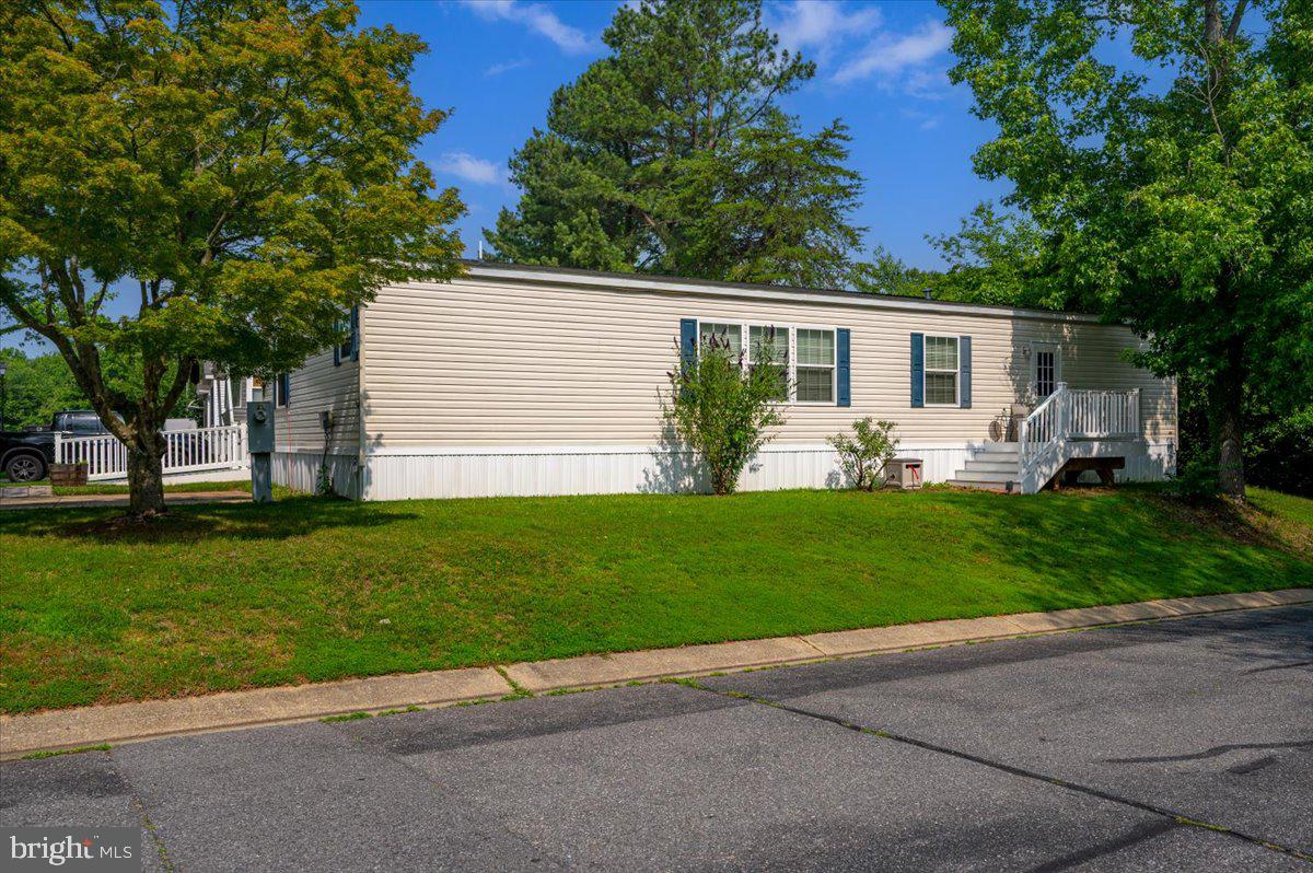 302 Berts Drive Lothian, MD 20711 - Photo 5 of 38 a front view of house with yard and green space