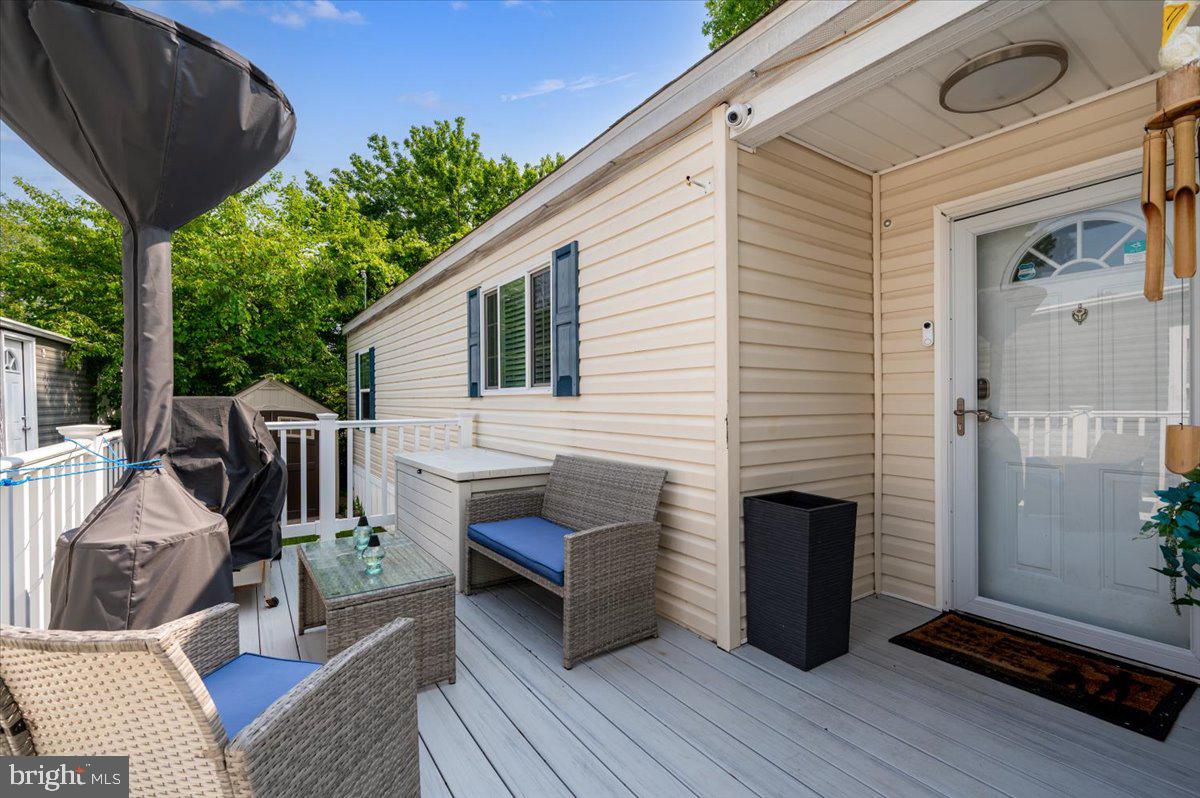 302 Berts Drive Lothian, MD 20711 - Photo 7 of 38 a view of a porch with furniture and wooden floor