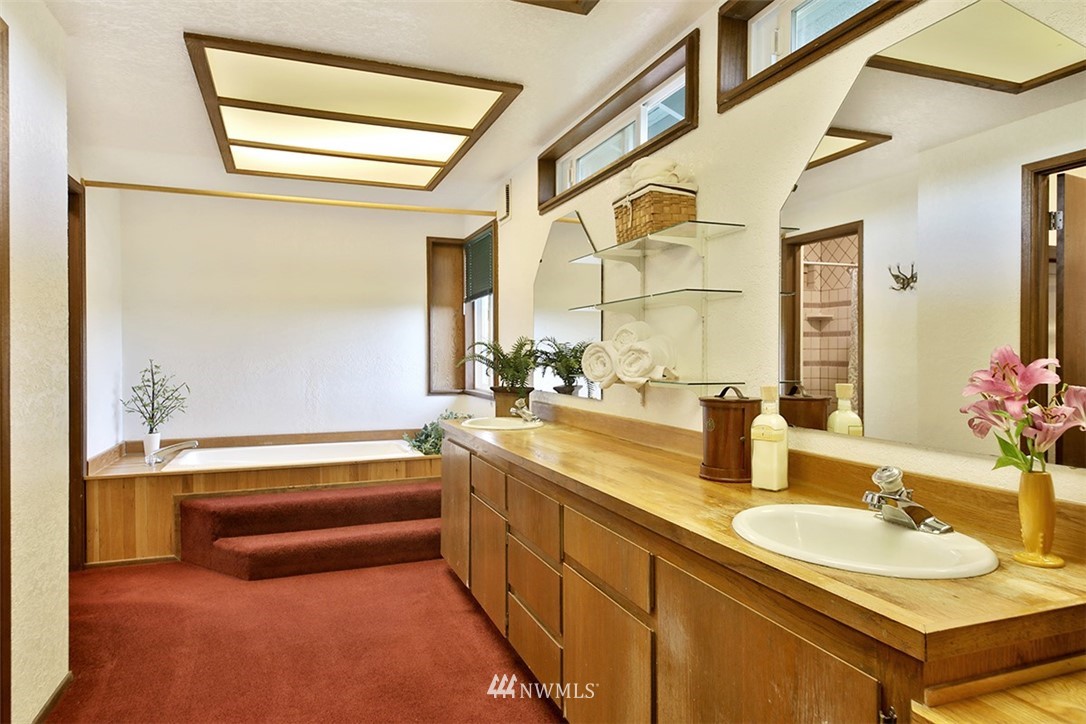 5749 Double Bluff Road Freeland, WA 98249 - Photo 21 of 40 a bathroom with a tub sink and mirror