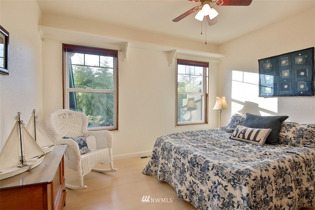 5749 Double Bluff Road Freeland, WA 98249 - Photo 23 of 40 a bedroom with a bed and wooden floor