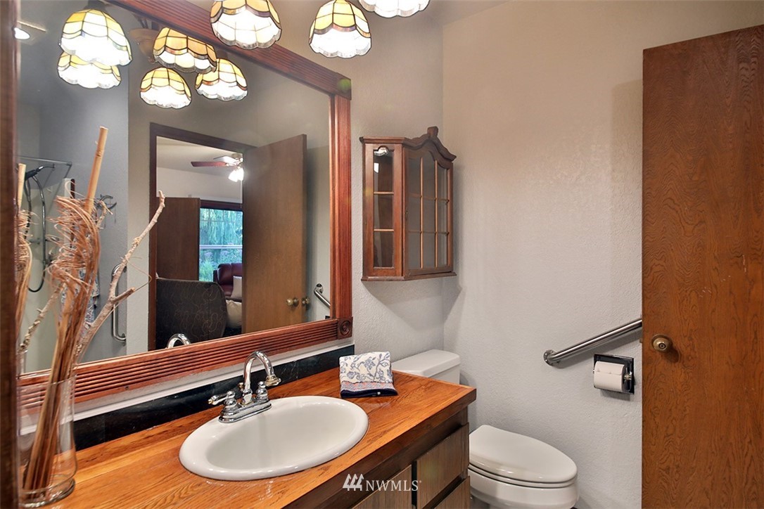 5749 Double Bluff Road Freeland, WA 98249 - Photo 26 of 40 a bathroom with a toilet a sink and a mirror