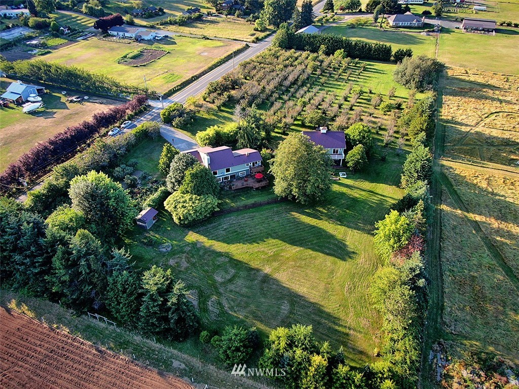 5749 Double Bluff Road Freeland, WA 98249 - Photo 4 of 40 an aerial view of a house with a garden and lake view