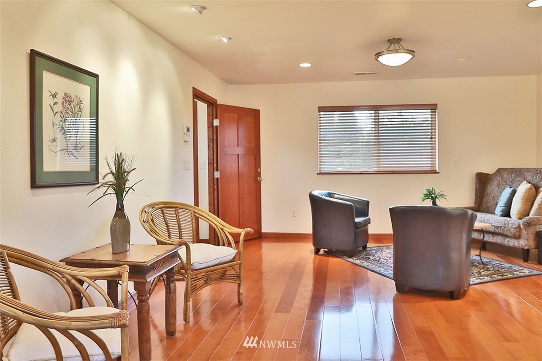 5749 Double Bluff Road Freeland, WA 98249 - Photo 32 of 40 a view of a dining room with furniture window and wooden floor