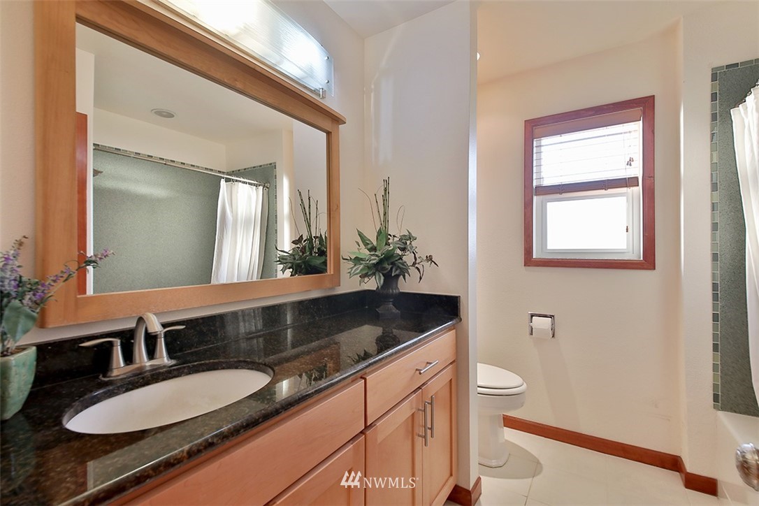 5749 Double Bluff Road Freeland, WA 98249 - Photo 35 of 40 a bathroom with a granite countertop sink and a mirror