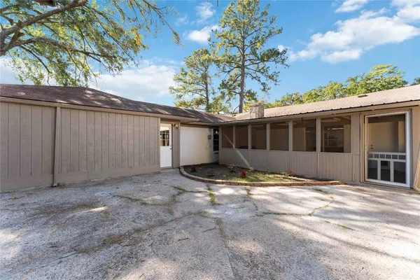 a view of a house with backyard and sitting area
